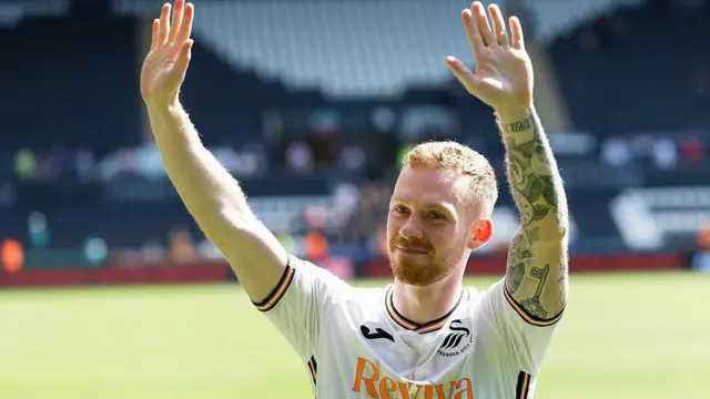 Lewis O'Brien waves to Swansea fans after their final game of the season