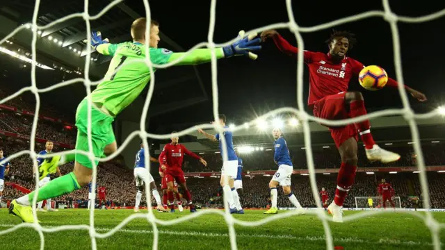 Divock Origi scores against Everton. Jordan Pickford attempts to save.