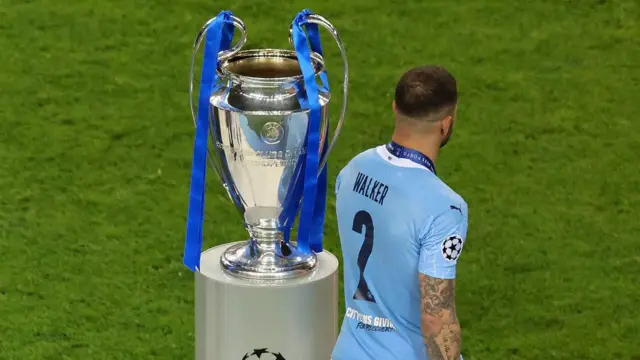 Kyle Walker next to the Champions League trophy