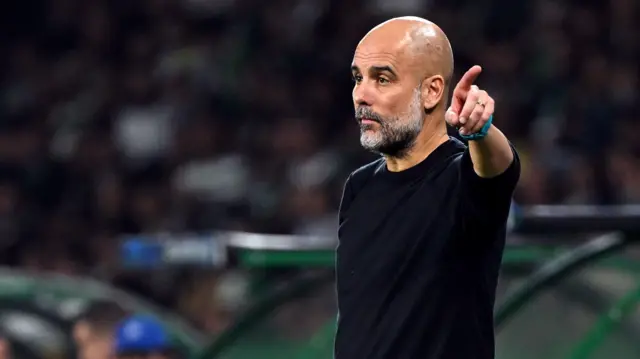 Pep Guardiola gestures from the touchline