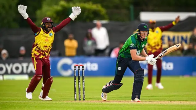 Ireland batter Harry Tector is bowled leg before wicket by West Indies bowler Roston Chase