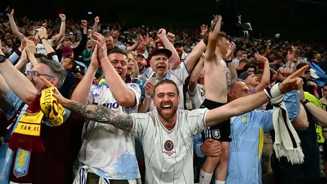 Aston Villa's supporters cheer for their team.