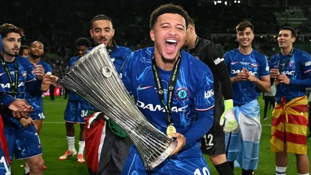 Jadon Sancho celebrates with the Conference League trophy 