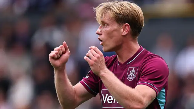 Burnley's Zian Flemming with both arms raised during the game against West Ham United