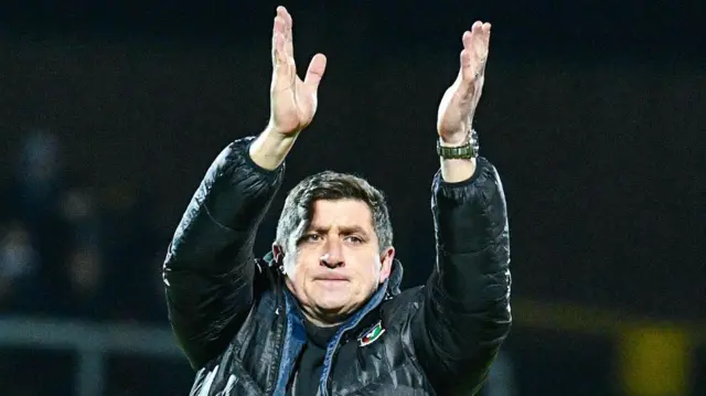 Glens boss Declan Devine applauds the Oval fans after beating Carrick