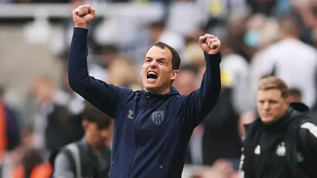Regis le Bris celebrating a Sunderland goal against Newcastle with a dejected Eddie Howe out of focus in the background