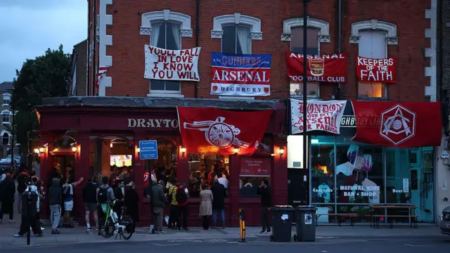 Arsenal fans decorate the streets with banners and flags