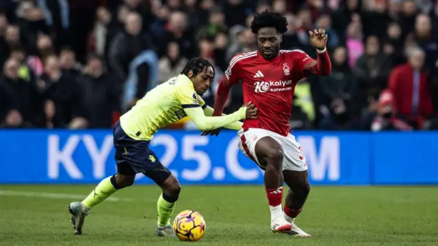 Ola Aina competing for the ball with Kyle Walker-Peters