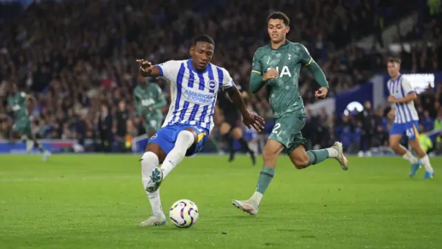  Brighton & Hove Albion's Pervis Estupinan battles with the ball against Tottenham Hotspur's Brennan Johnson