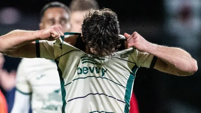 Hibernian's Joe Newell tears his shirt at full time during a cinch Premiership match between Ross County and Hibernian at the Global Energy Stadium