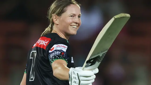Meg Lanning raises her bat after hitting a century