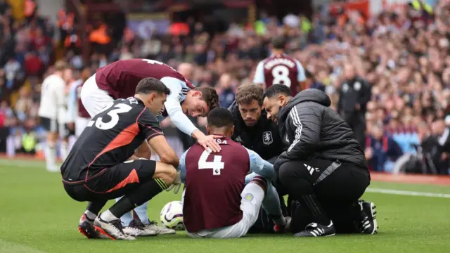 Team mates check on Ezri Konsa of Aston Villa as he is treated for an injury