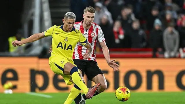 Kristoffer Ajer of Brentford and Richarlison of Tottenham battle for the ball
