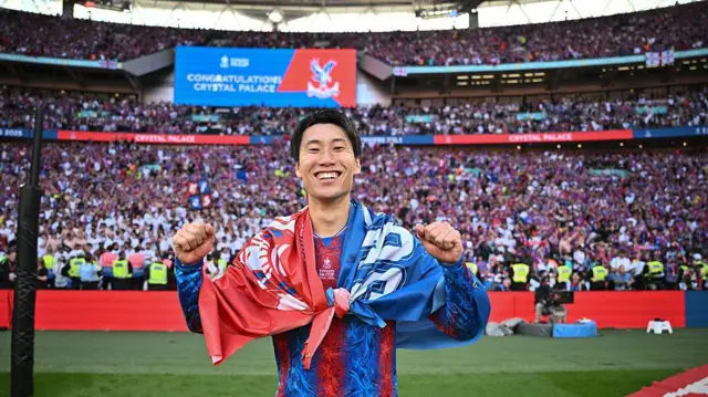 Daichi Kamada of Crystal Palace celebrates with fans