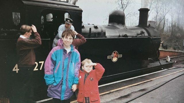 Christine McCulloch with her son Adam with a train in the background