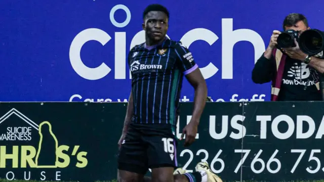 Adama Sidbeh slides on his knees after scoring against Motherwell