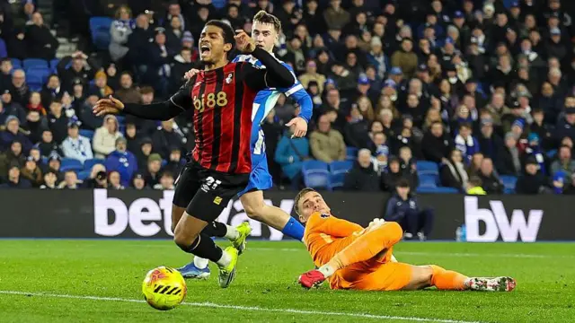 Bart Verbruggen of Brighton & Hove Albion brings down Bournemouth's Amine Adli as he runs through on goal