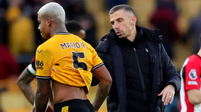 Gary O'Neil consoles his Wolves players after a defeat