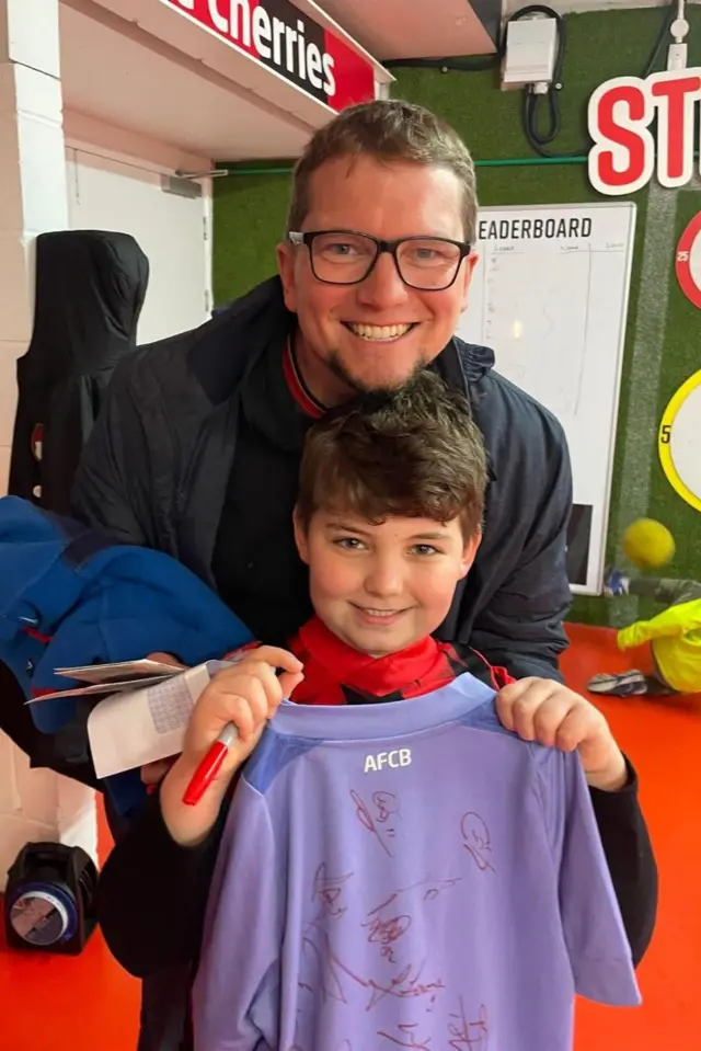 Father and son with signed Bournemouth shirt
