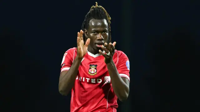 Wrexham's right wing-back Issa Kabore applauds fans