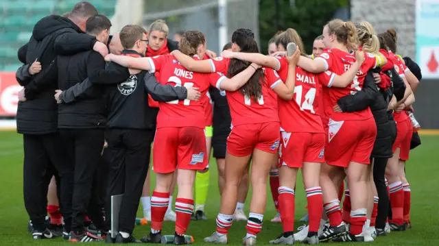 Wrexham Women's team in a huddle