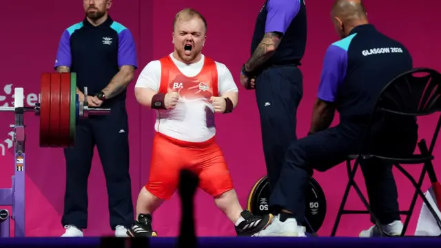 Matthew Harding celebrates his lift in his England powerlifting kit during the Commonwealth Games in Glasgow