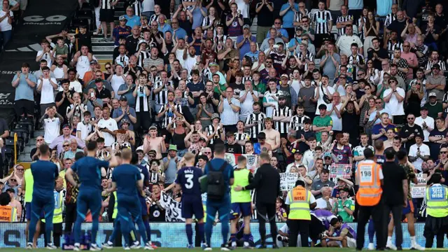 Fans of Newcastle United applaud the players