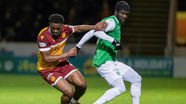 Motherwell's Marvin Kaleta battles with Hibernian's Elie Youan