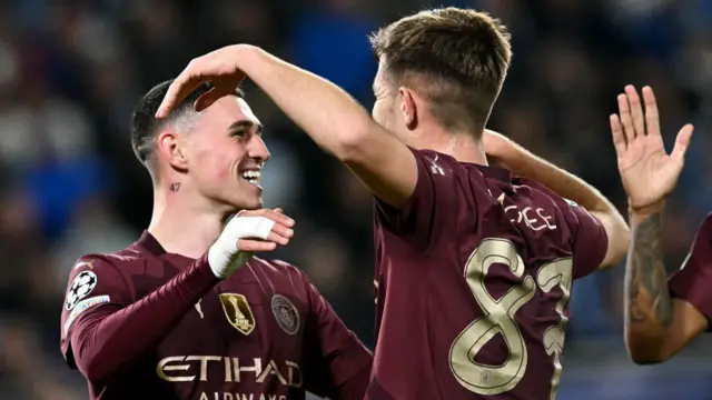 James McAtee celebrates scoring his team's fourth goal with team mate Phil Foden