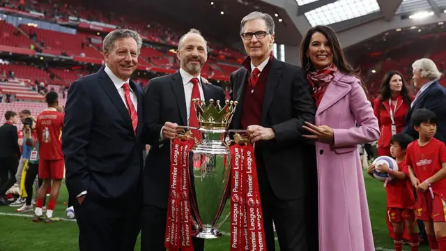 om Werner, Chairman of Liverpool, Michael Gordon, President of Fenway Sports Group and John Henry, Principle Owner of Liverpool and his wife Linda Pizzuti Henry pose for a photograph with the Premier League trophy, as Liverpool are crowned the Champions of the Premier League for the 2024/25 Season,