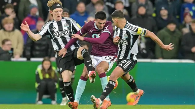 Burnley's Armando Broja is challenged by Newcastle players