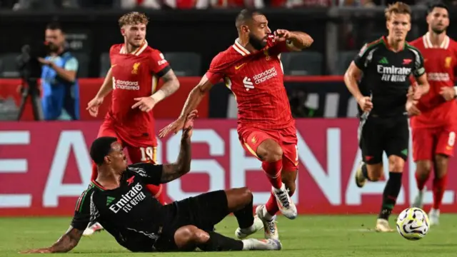 Gabriel of Arsenal tackles Mohamed Salah