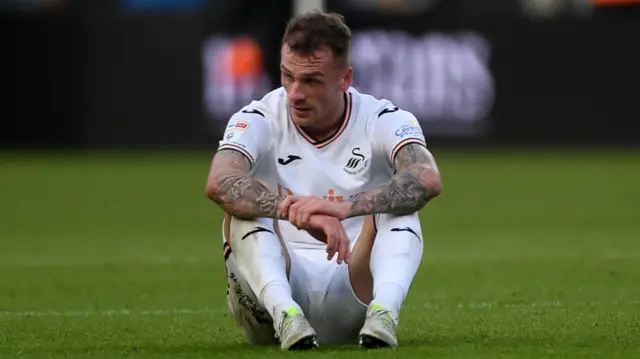 Swansea City left-back Josh Tymon looks dejected