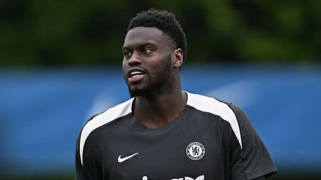 Badiashile smiling in training in May