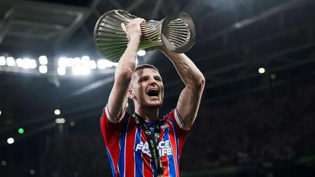 Adam Wharton lifts the Conference League trophy