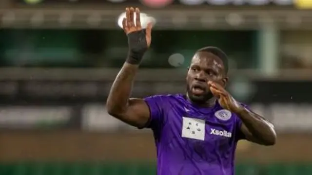 Striker Tyreece Simpson, wearing a purple Stevenage shirt, waves after the match away at Norwich City