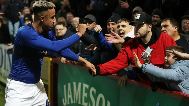 Cardiff City striker Callum Robinson celebrates with fans after his late goal beats Stevenage