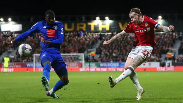 James McClean shoots during Wrexham's league meeting with Harrogate in March