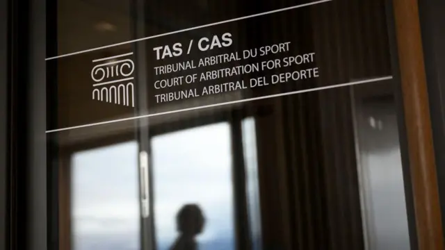 A man is seen in silhouette in the offices of the Court of Arbitration of Sport