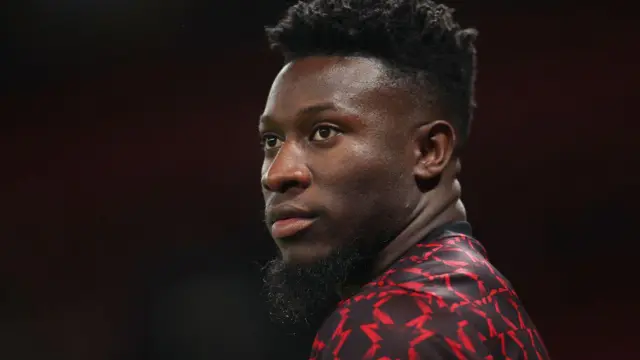 Andre Onana of Manchester United looks on as he warms up prior to the Carabao Cup Fourth Round match between Manchester United and Leicester City at Old Trafford