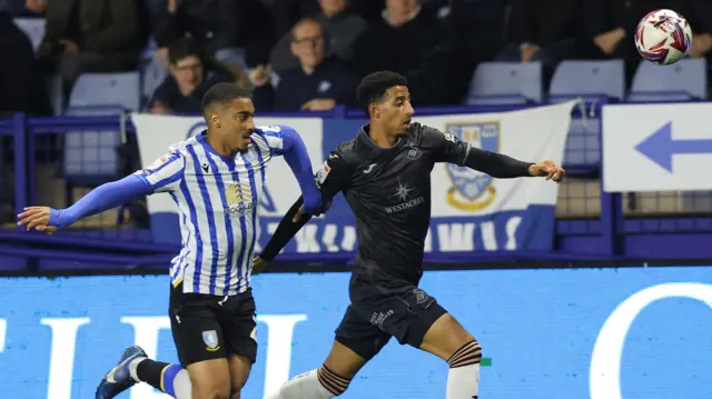 Sheffield Wednesday's Yan Valery battles with Swansea City's Azeem Abdulai