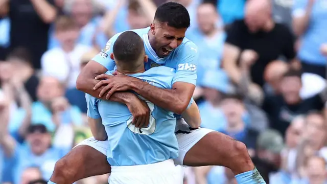 Kyle Walker and Rodri embracing