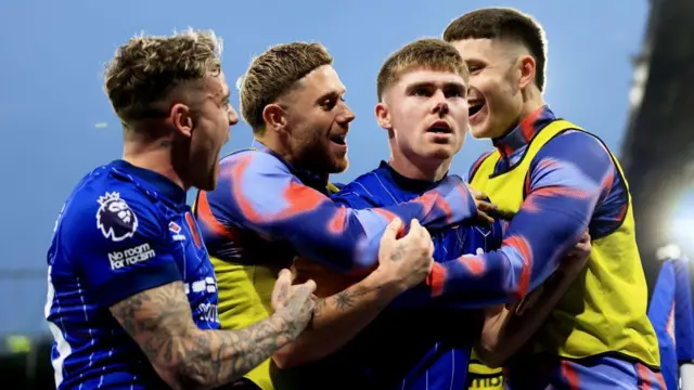 Leif Davis of Ipswich Town celebrates scoring his team's first goal with teammates during the Premier League match between Ipswich Town FC and Leicester City FC at Portman Road