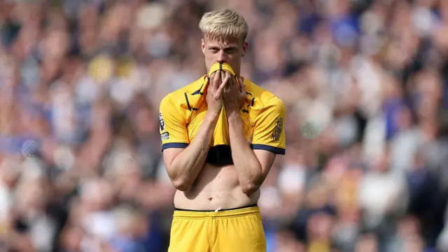 Jean Paul van Hecke wipes his mouth with his shirt and looks sad or frustrated