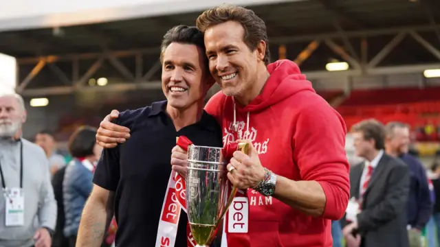 Rob McElhenney (left) and Ryan Reynolds with trophy