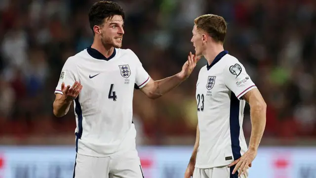 Declan Rice and Elliot Anderson talk to each other on the pitch during an England match