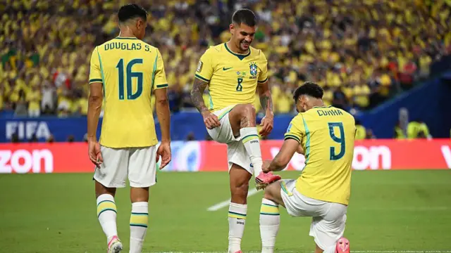 Matheus Cunha of Brazil celebrates with Bruno Guimaraes by pointing at the Newcastle player's right boot