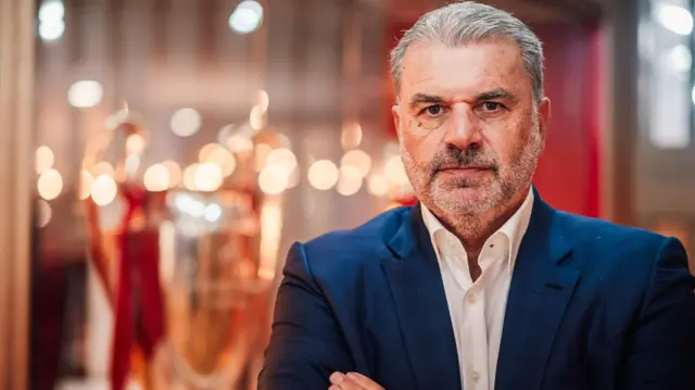 Ange Postecoglou poses infront of the European Cup