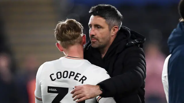 Ollie Cooper embraces Alan Sheehan last season 