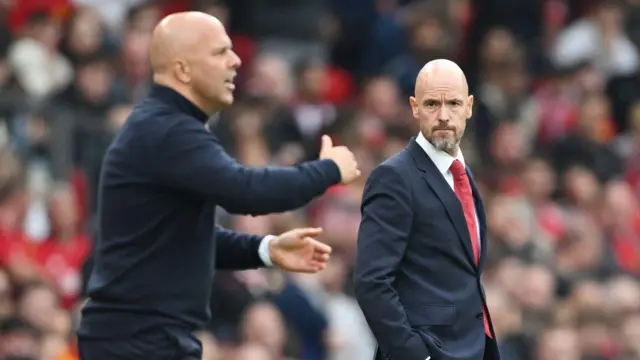 Erik ten Hag, Manager of Manchester United, looks on, as Arne Slot, Manager of Liverpool, gestures